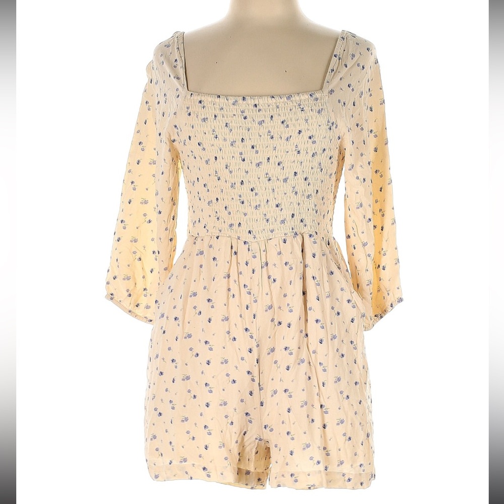 American Eagle size medium cream colored romper with blue flowers
